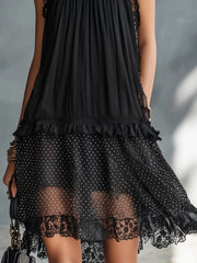 Vestito corto nero a pois trasparente con bordo in pizzo e balze