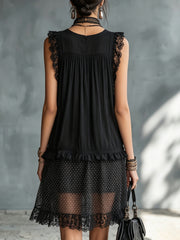 Vestito corto nero a pois trasparente con bordo in pizzo e balze